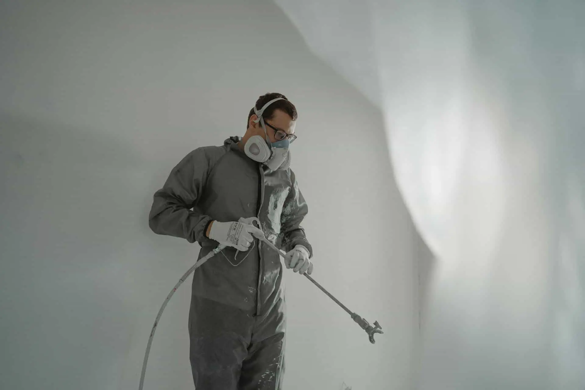 man painting with sprayer